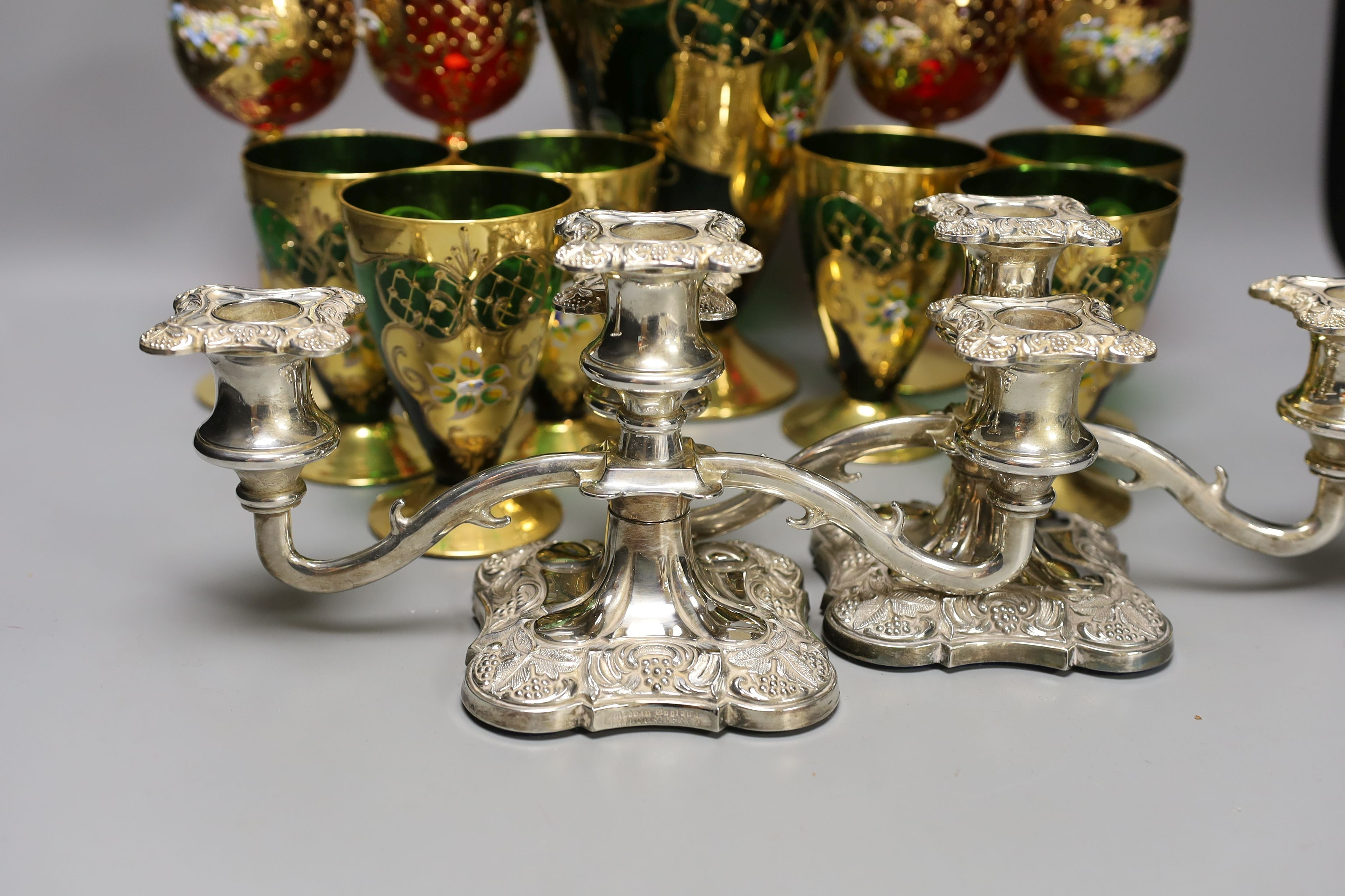 A Venetian green glass lemonade set, 4 red glass wine glasses and a pair of plated candelabra, jug 29 cms high.